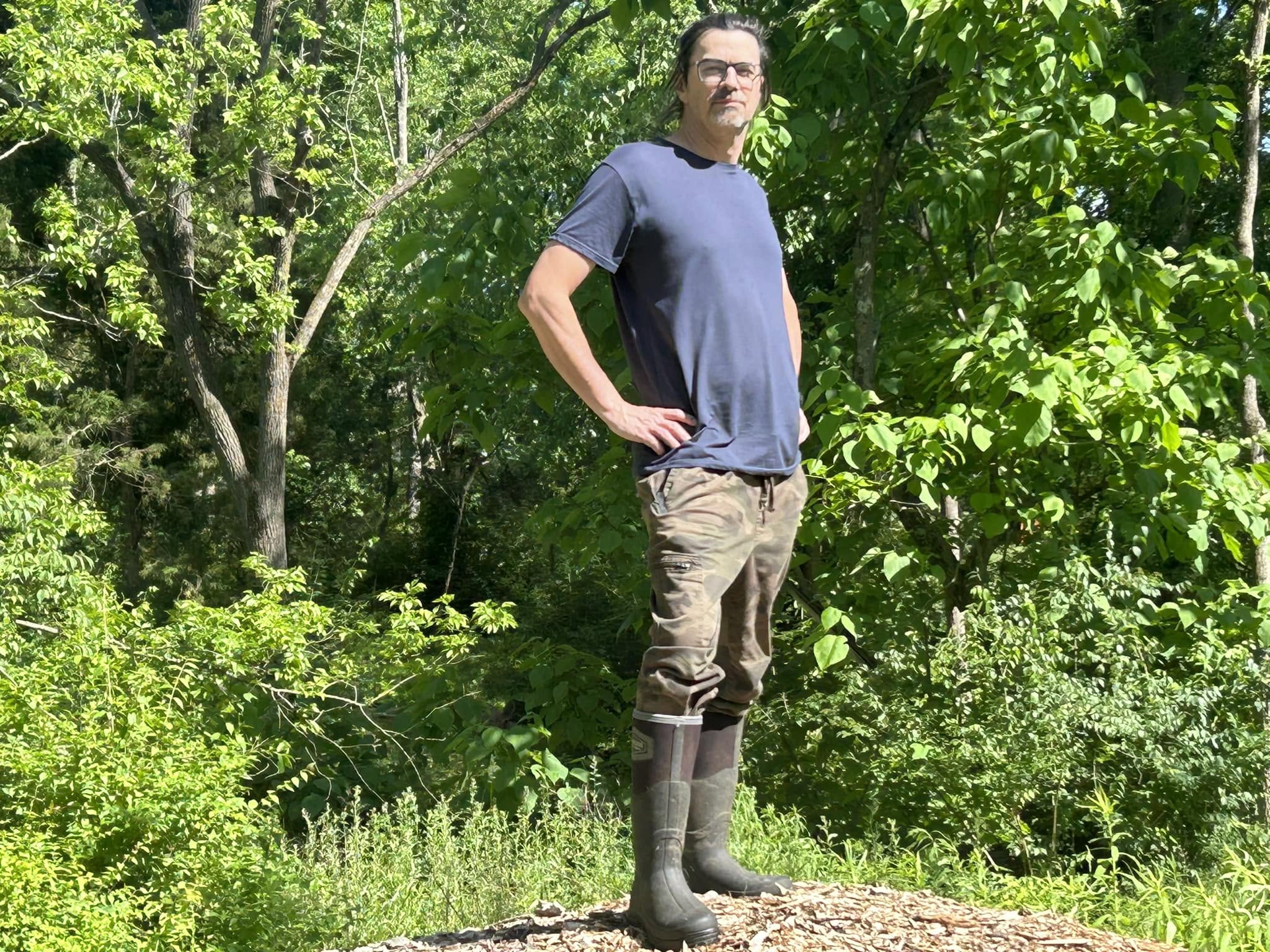 David standing on a mound at the farm